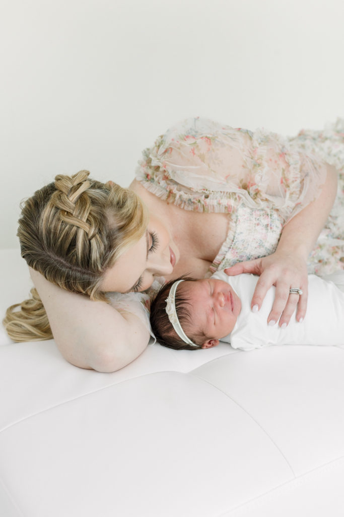 Mom snuggles her baby girl during their portrait session.